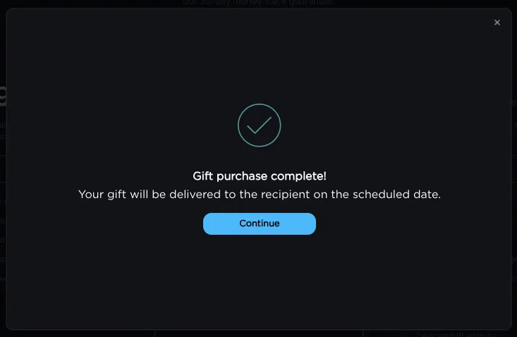 Gift purchase confirmation screen showing a checkmark icon, the message 'Gift purchase complete!', and a note that the gift will be delivered to the recipient on the scheduled date, with a Continue button.